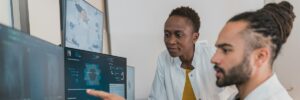 Researchers reviewing data on screen